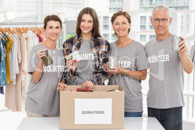 Smiling volunteers showing donations