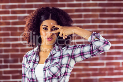 Attractive young woman showing peace sign