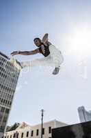 Extreme athlete jumping in front of building