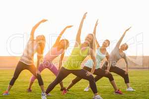 Sporty women warming up during fitness class