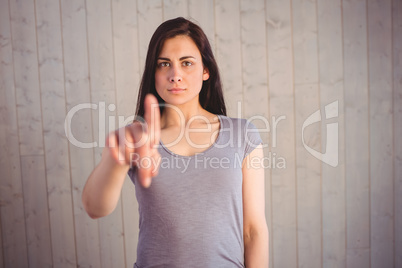 Pretty brunette pointing with finger