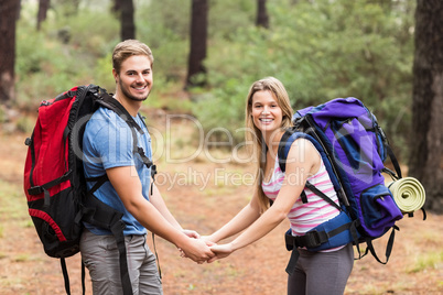 Young happy hiker couple holding hands