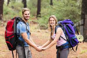 Young happy hiker couple holding hands