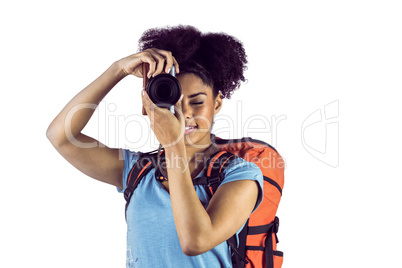 Young woman with backpack taking picture