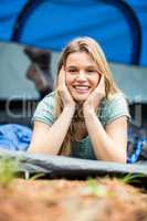 Portrait of a young pretty hiker lying in a tent