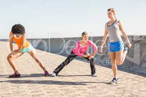 Sporty women stretching together