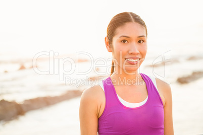 Fit woman smiling to camera at promenade