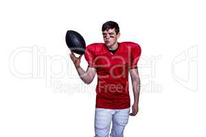 American football player playing with the ball