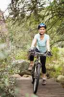 Smiling fit woman taking a break on her bike