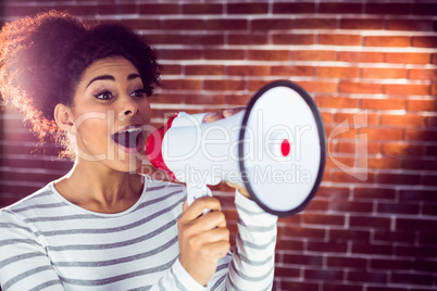 Young woman using her megaphone in the light