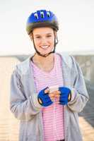 Smiling sporty blonde skater enjoying music