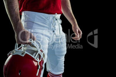 American football player holding his helmet