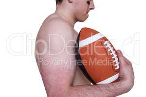 Shirtless american football player holding a ball