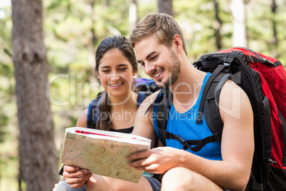 Young happy joggers looking at map
