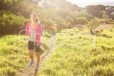 Fit woman jogging in the forest