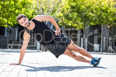 Handsome athlete doing a side plank