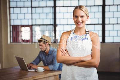 Smiling blonde waitress posing in front of customer