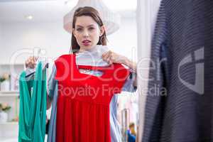Woman deciding between two dresses