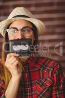 Beautiful hipster with mustache on wallet