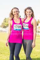 Two smiling blondes supporting breast cancer marathon