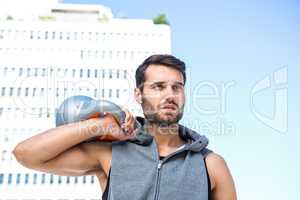 Handsome athlete holding kettle bell
