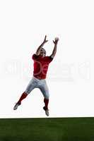 American football player trying to catch football