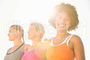 Smiling sporty woman with two friends