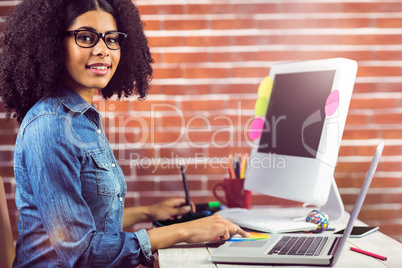 Casual female designer smiling and working
