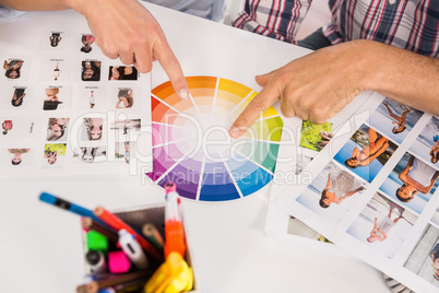 Casual designers working with colour chart and photographs