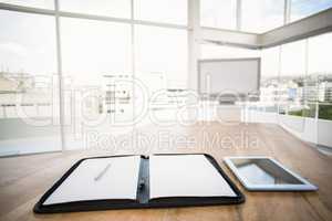 Tablet and planner in front of meeting room
