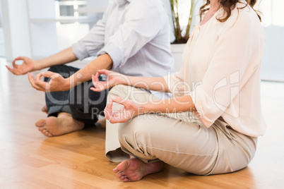 Peaceful casual business colleagues meditating