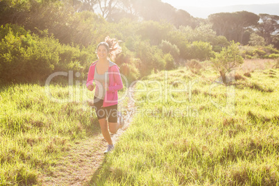 Fit woman jogging in the forest