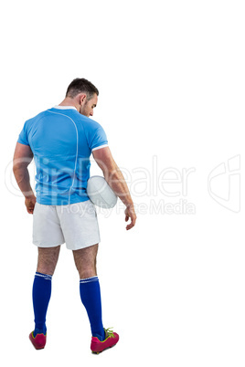 Rugby player standing with ball