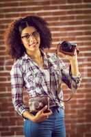 Attractive smiling hipster showing camera
