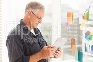 Attentive businessman looking at his tablet