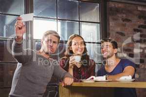 Friends having coffee and taking funny selfies