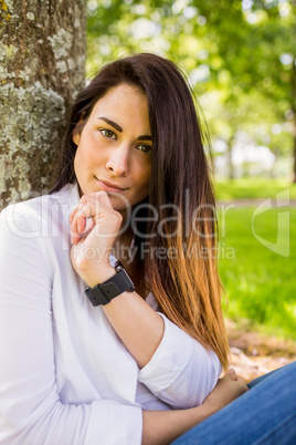 Beautiful brunette thinking in the park