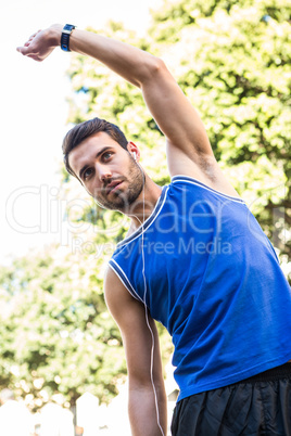 Handsome athlete stretching