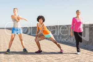 Sporty women stretching together