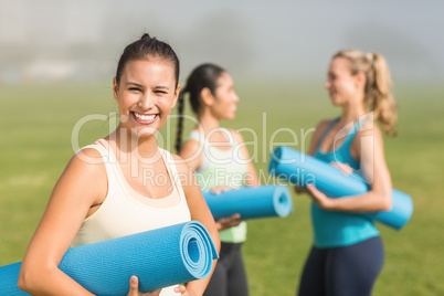 Smiling sporty brunette in front of friends