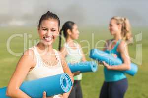 Smiling sporty brunette in front of friends