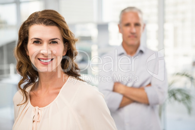 Smiling casual businesswoman in front of her colleague