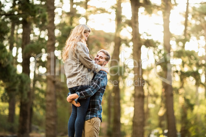 Smiling handsome man holding his girlfriend