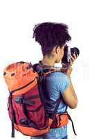 Young woman with backpack taking picture