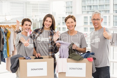 Smiling volunteers with donation boxes