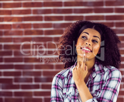 Attractive young woman smiling and daydreaming