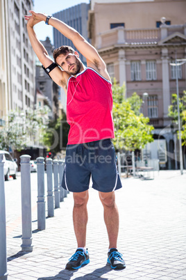 Handsome athlete doing arms stretching