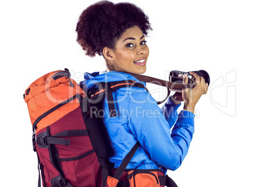 Portrait of a young woman with backpack taking picture