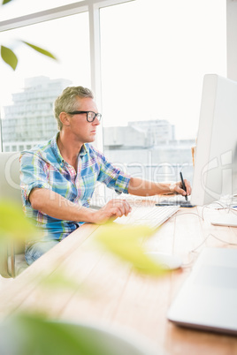 Casual designer using computer and digitizer Casual designer using computer and digitizer