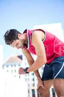 Exhausted athlete looking at his stopwatch